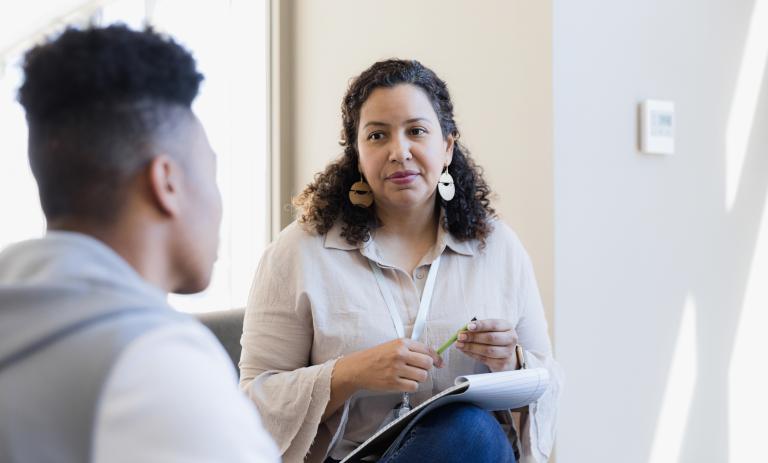 psychiatrist listens to a young adult