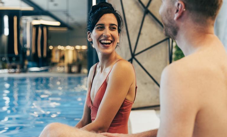 A couple having fun by the pool