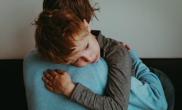 Adult comforting sad child