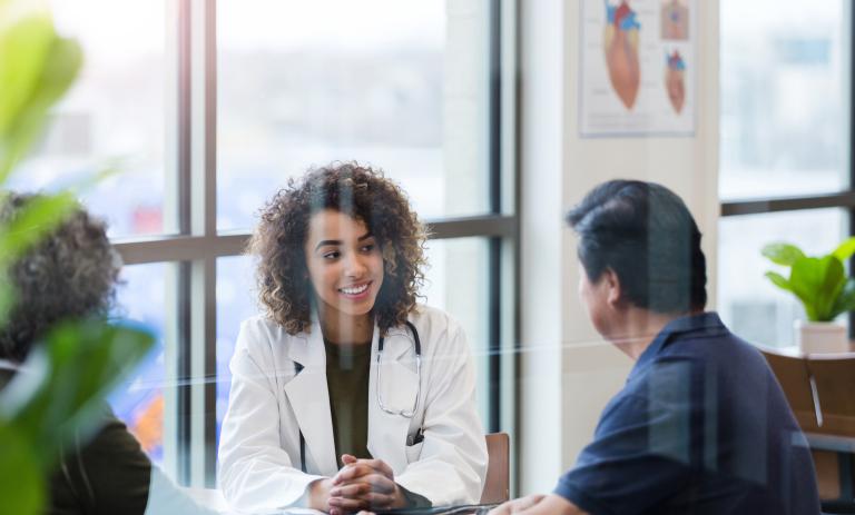Doctor consults with a senior couple in their office