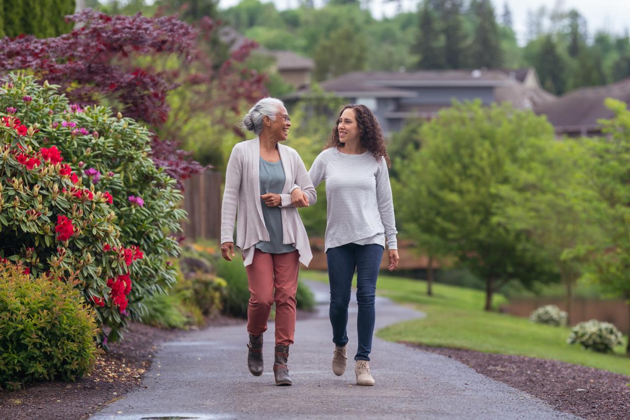 A senior person walking with their child