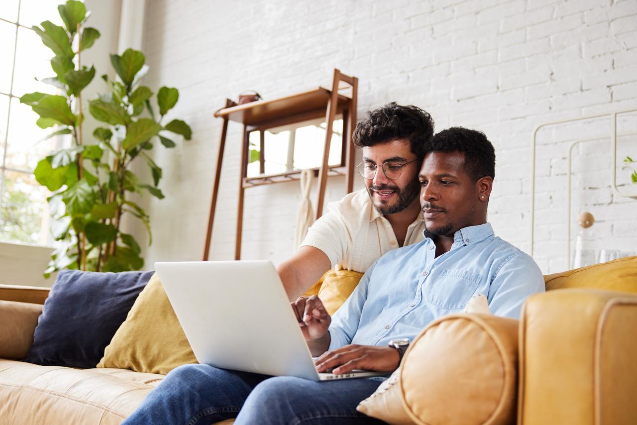A couple using a patient guide on a laptop together while at home