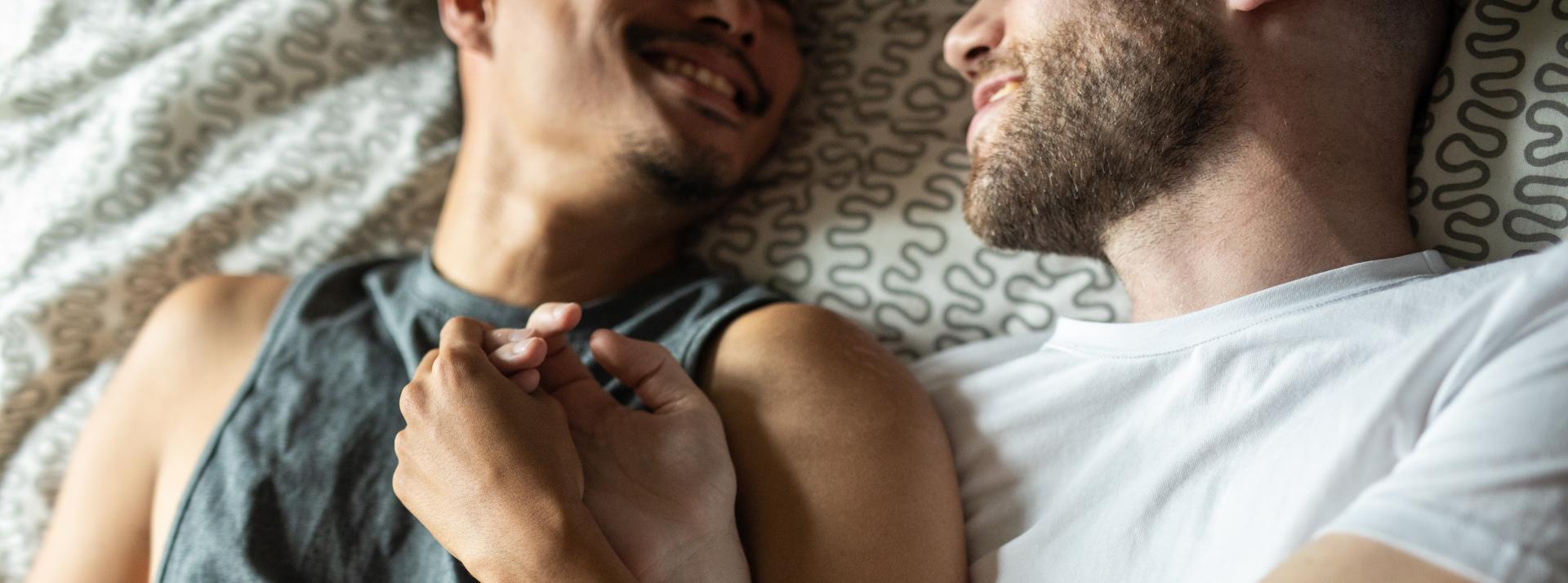 A happy couple lying in bed
