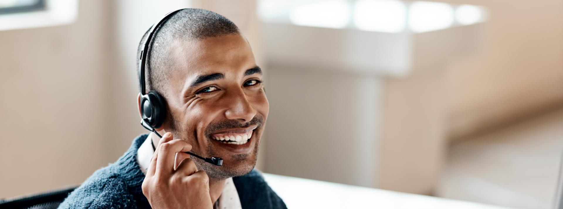 person sitting at desk on phone