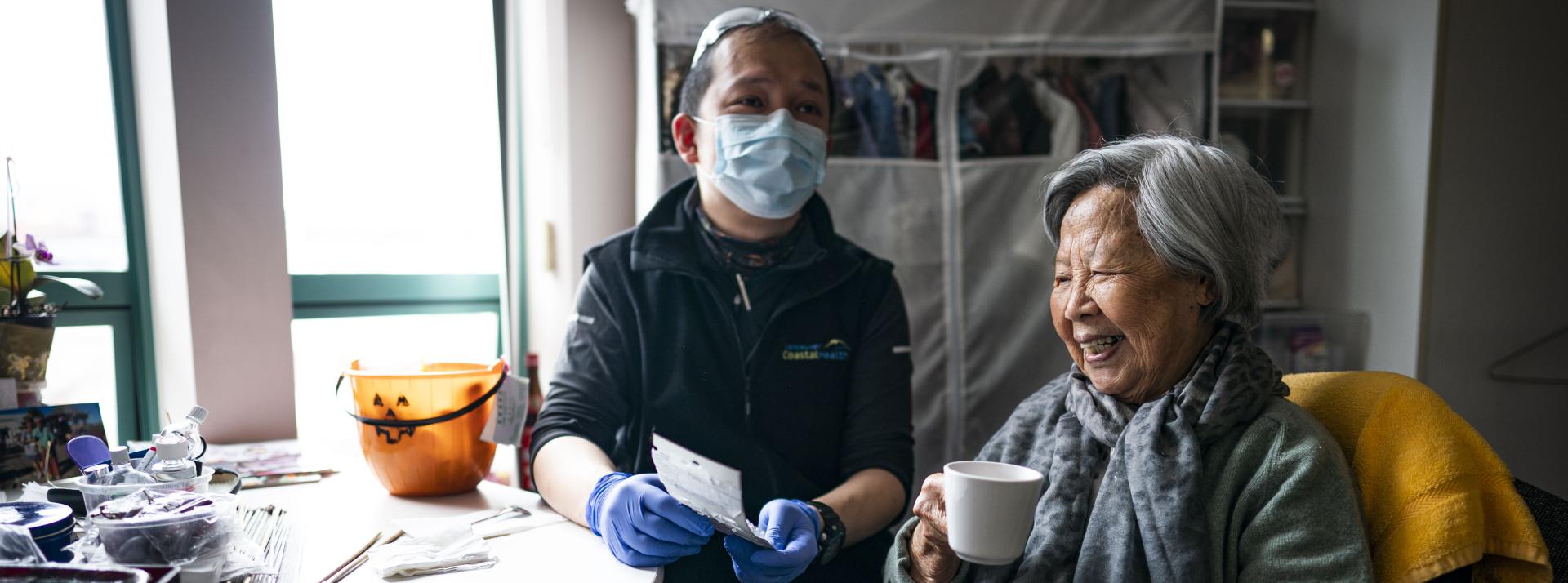 Community Health Worker Bon with client