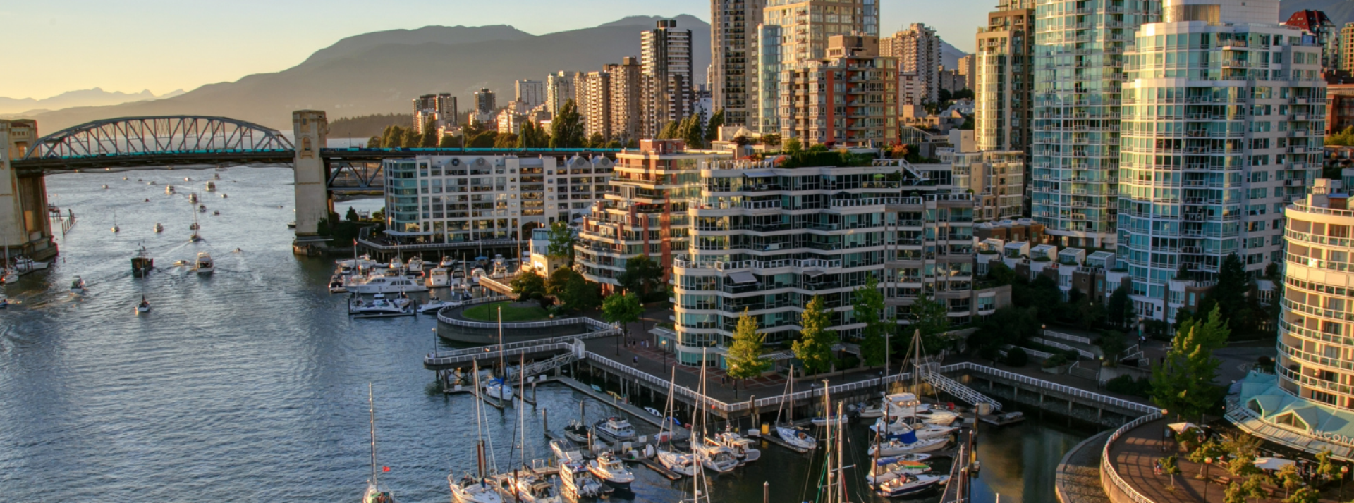 Downtown Vancouver cityscape with bridge and water.