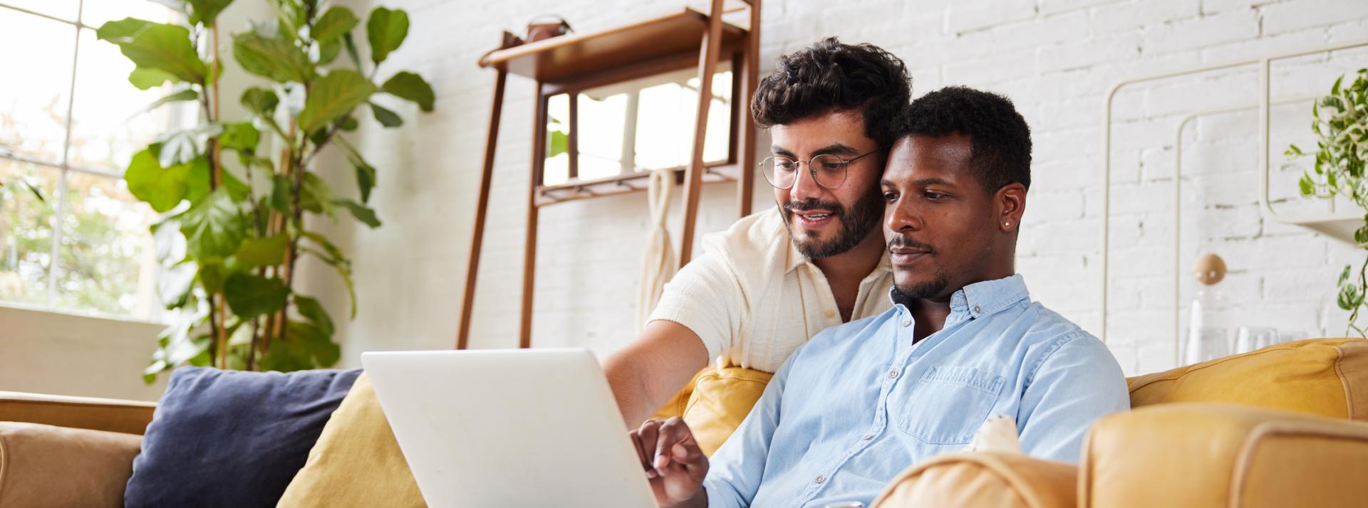 A couple using a patient guide on a laptop together while at home
