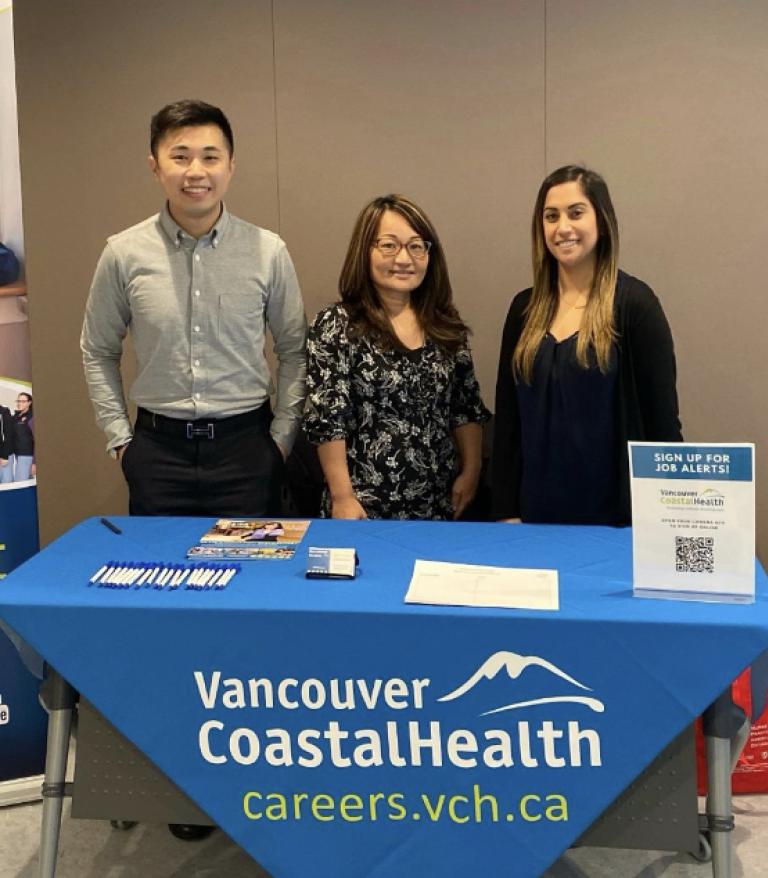 Talent Acquisition team standing behind VCH table