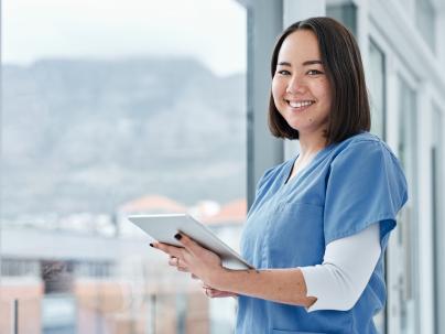 Portrait of a medical practitioner using a digital tablet in a hospital.