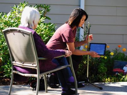Elderly woman being assisted with a health-care worker