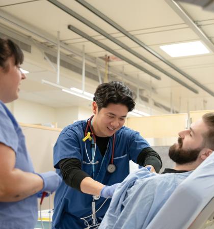 Image of a nurse and doctor assisting a patient 