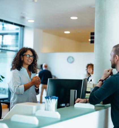 Person at desk talking to people